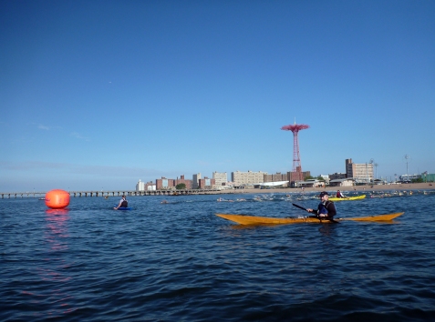 Kayaker’s-eye view. Terry in my favorite boat with the Grimaldo’s Mile swimmers coming out to round first buoy behind him